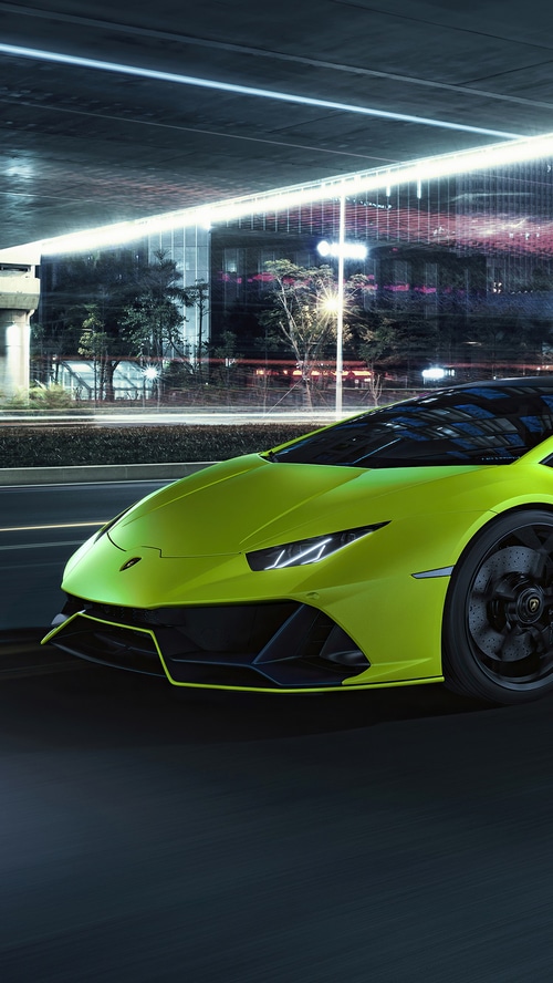 Lime green Lamborghini Huracan Evo driving at night