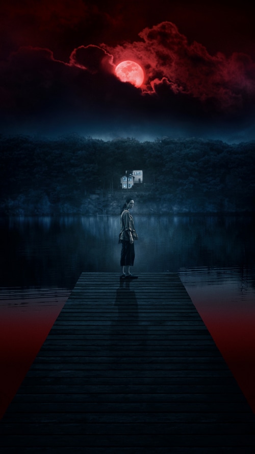 A woman stands on a dock under a red moon