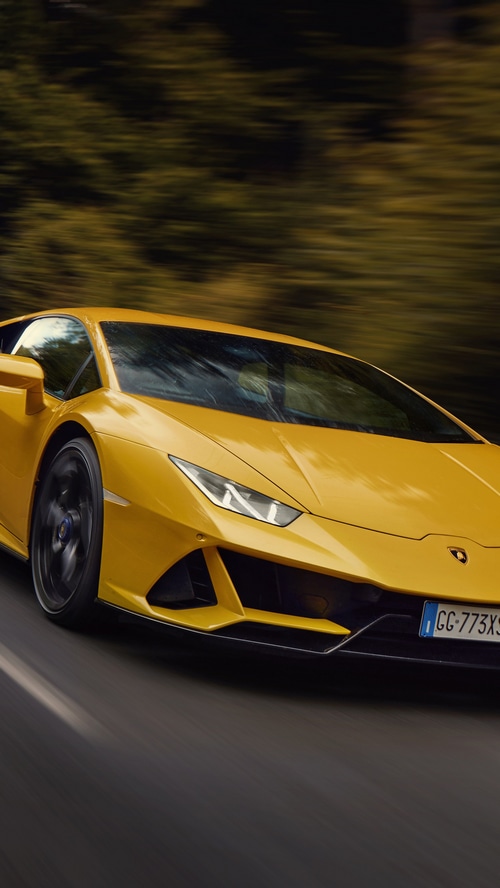 Yellow Lamborghini Huracan Evo driving on road