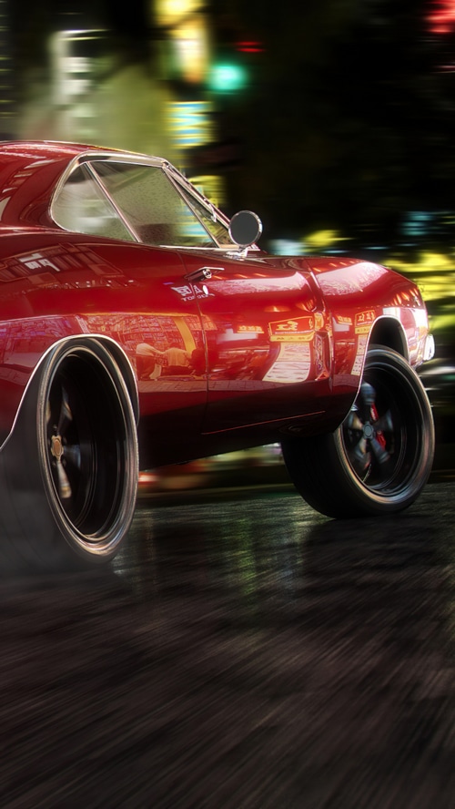 Red classic car driving at night