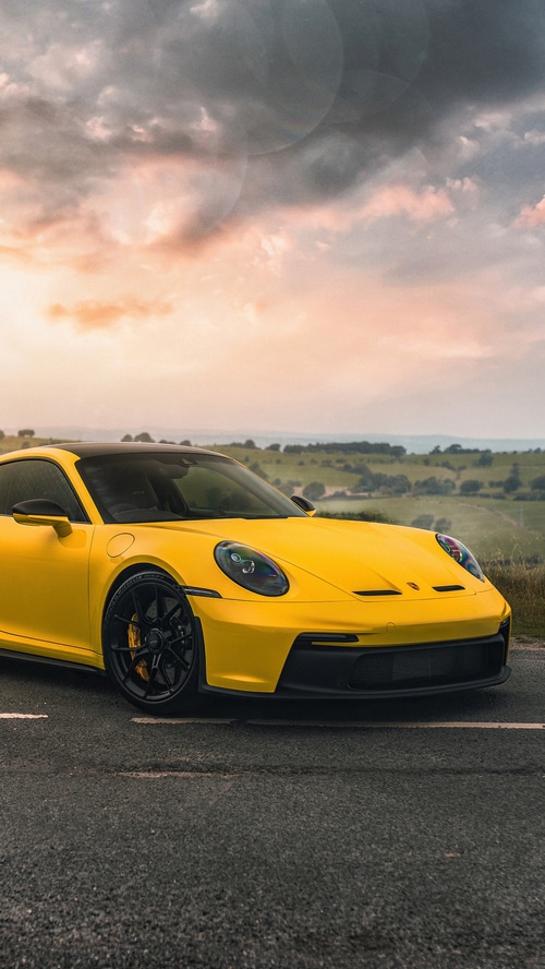 Yellow Porsche 992 on a Country Road