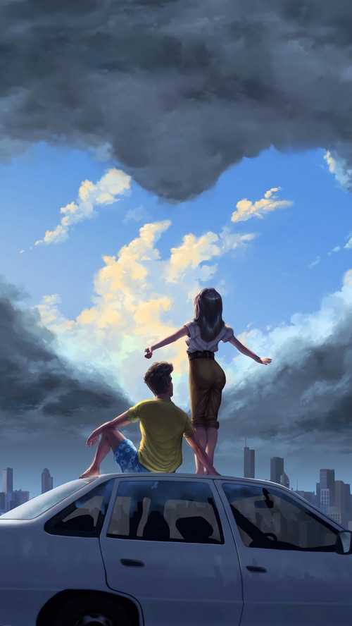 Couple on car roof looking at heart-shaped clouds