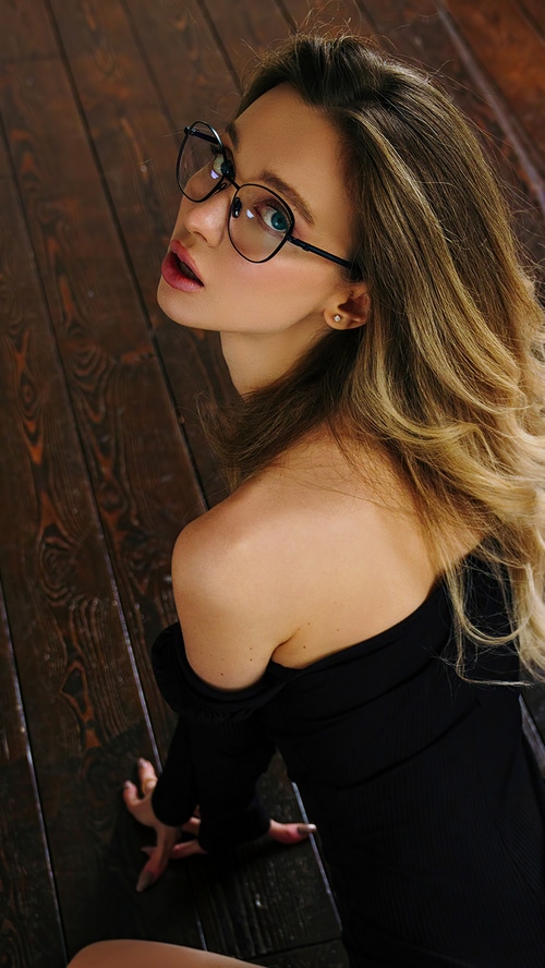 Model with glasses on wooden floor
