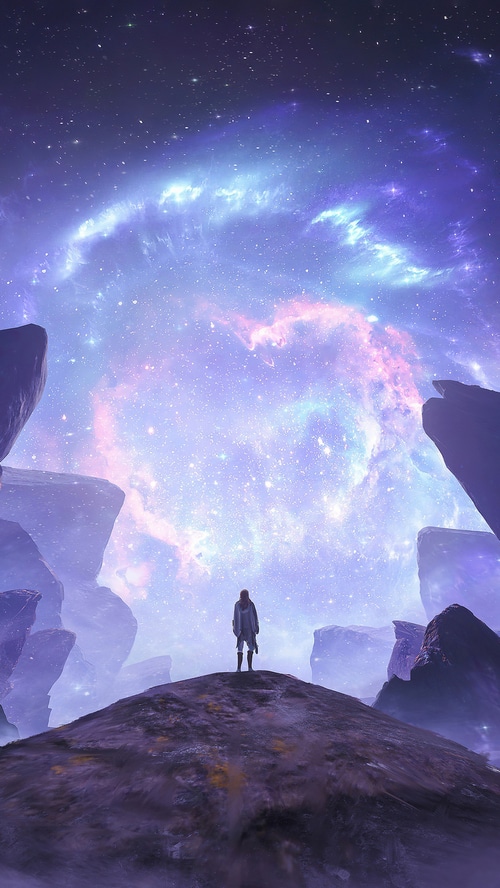 Person standing on a rocky hill under a colorful nebula