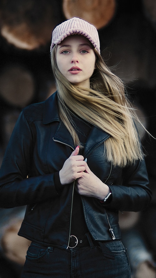 Girl in leather jacket and pink cap