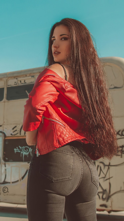 Brunette model in red jacket and jeans