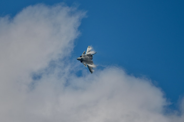 Chengdu J-20 fighter jet flying through clouds