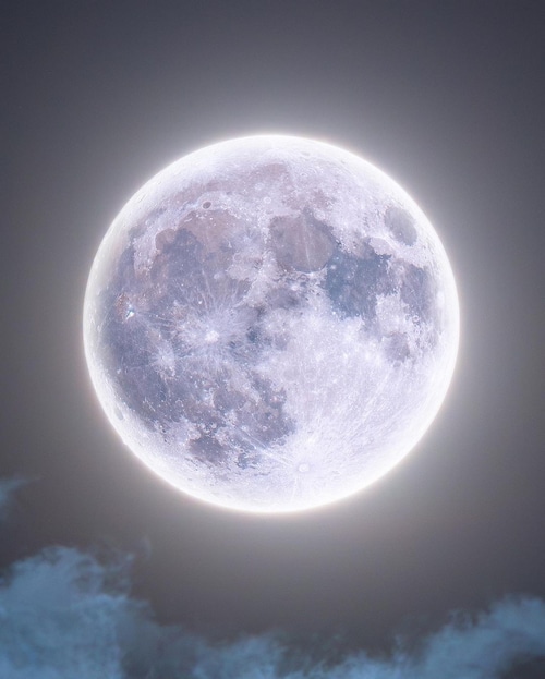 Full moon with clouds in the night sky