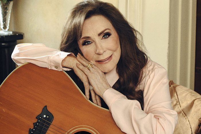 Loretta Lynn with her guitar