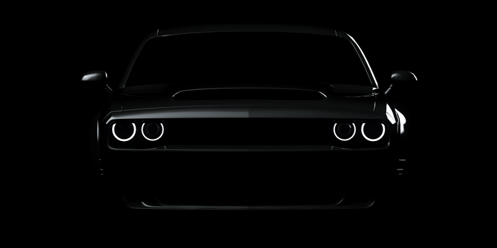 Dodge Challenger with glowing headlights on black background