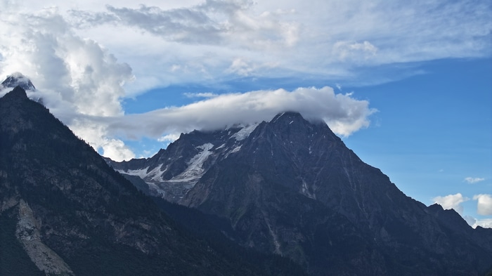 4K snowy mountain peaks under clouds