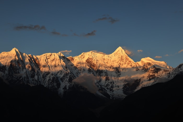 Snowy mountain peaks at sunset in Tibet