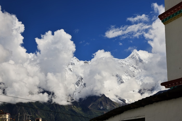 Snowy Peak in Tibet Under Blue Sky with Clouds