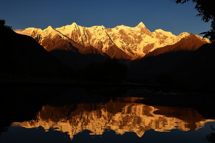 Snowy peaks of Tibet, China illuminated by sunset