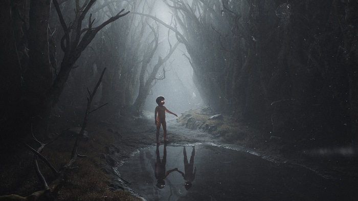 Child with glowing eyes in a misty forest