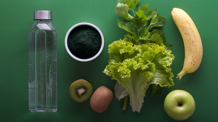 4K still life of fruits, vegetables, and spirulina powder