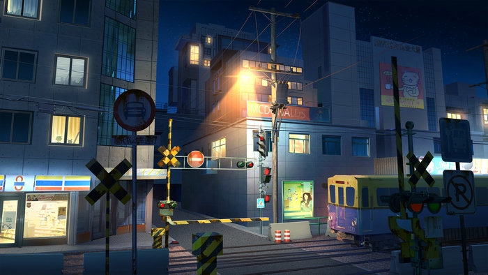 Train crossing at night with McDonald's and convenience store