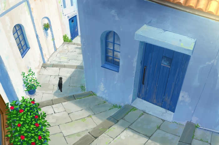 Black cat walks on a sunlit Mediterranean street with blue doors and flowers