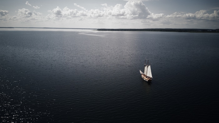 4K drone photo of a ship sailing on the sea