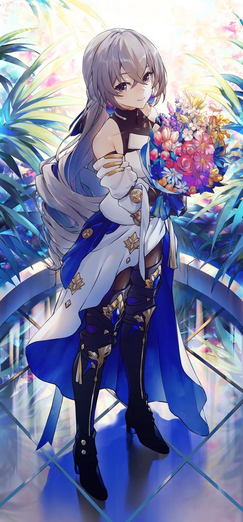 Bronya Rand holding flowers with plants in the background