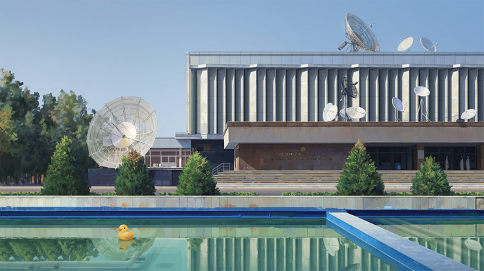 A rubber duck floats in a swimming pool in front of a building with satellite dishes.