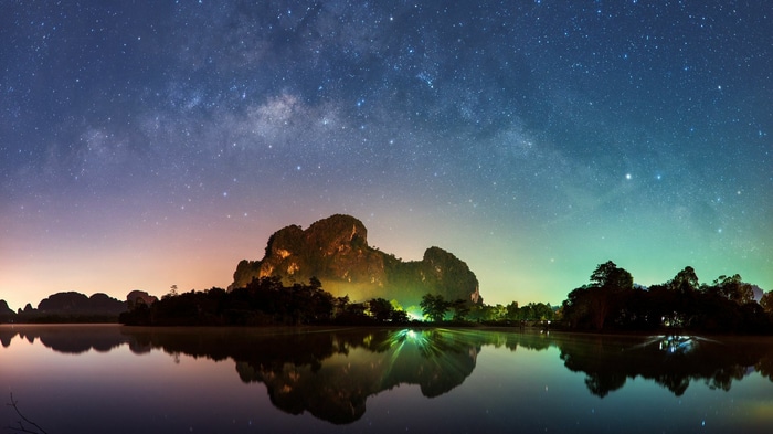 Milky Way over a lake and karst mountains at night