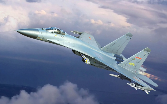 Chinese J-11 fighter jet with missiles in flight