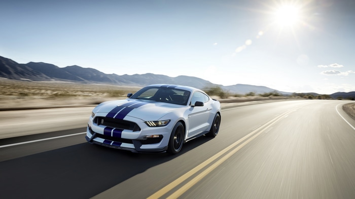 White Ford Mustang Apollo Edition driving on a desert road