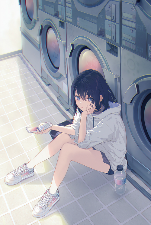Girl sitting in a laundromat with a phone