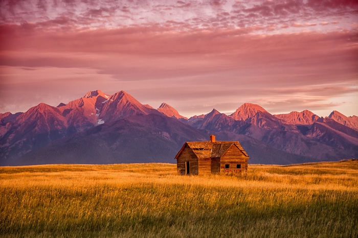 Abandoned cabin in Montana mountains at sunrise