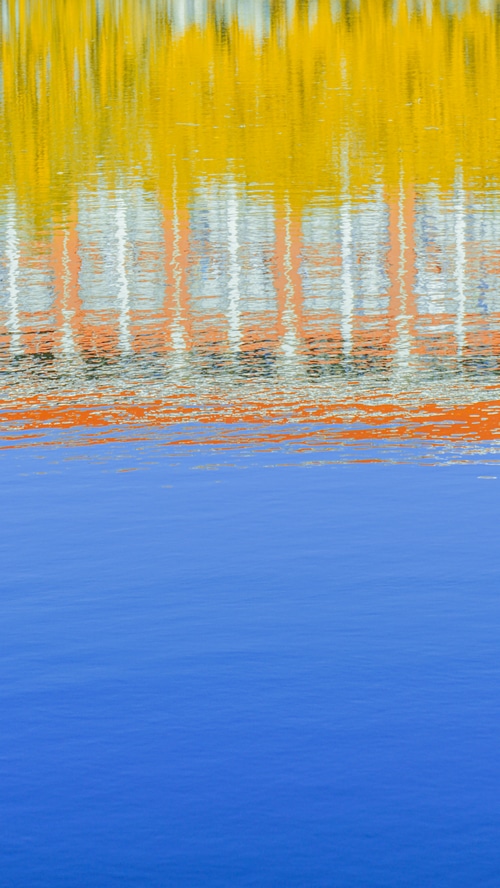 Reflection of a building in blue water