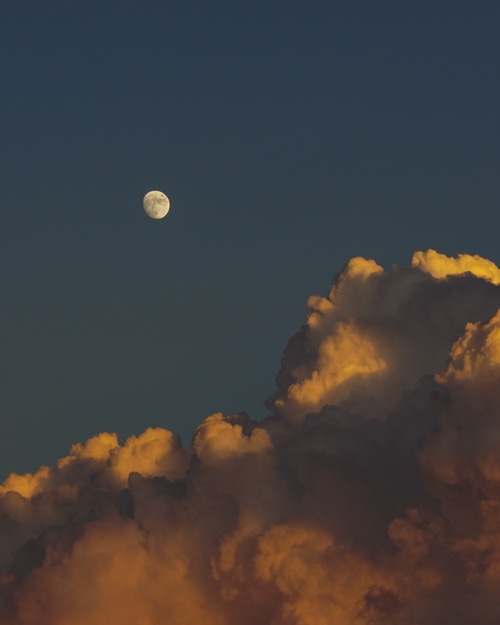 Moon and clouds at sunset