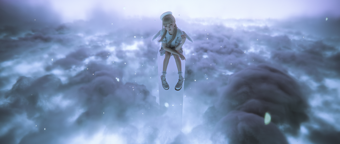 Fantasy girl with wings sitting on a cloud