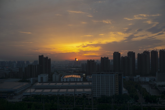 4K Sunset Glow Over Cityscape with Buildings
