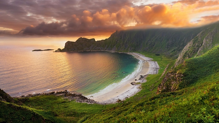 4K sunset over a bay with mountains and beach