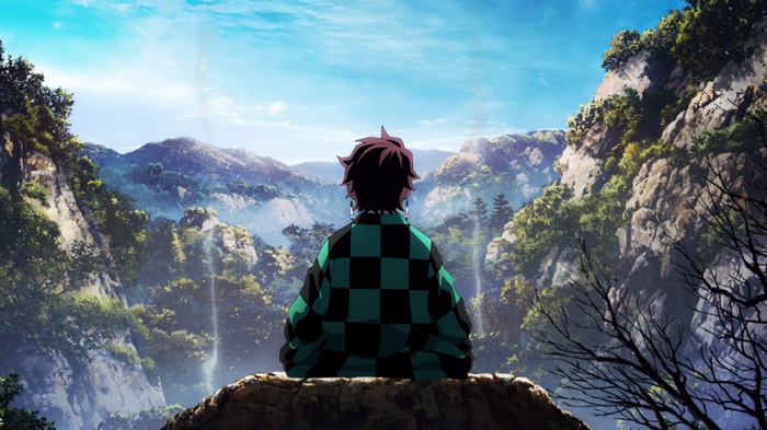 Kamado Tanjiro sitting on a rock overlooking mountains