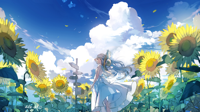 Girl in a sunflower field under a blue sky