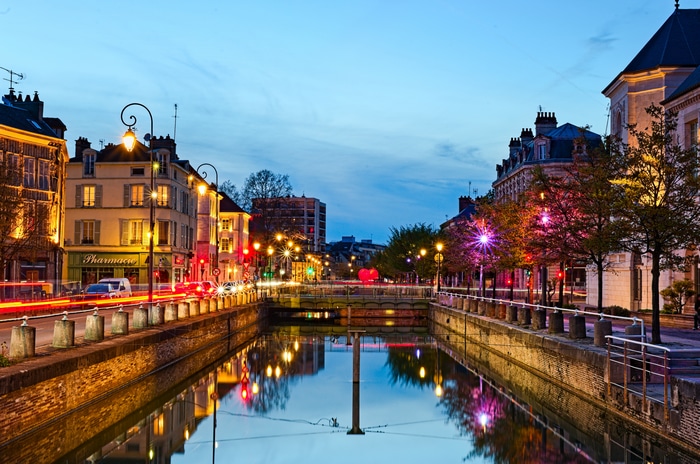 Canal in France at Dusk with City Lights