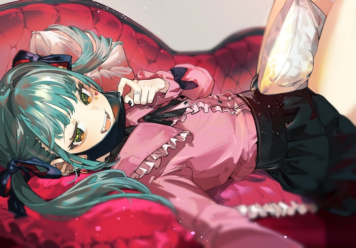 Hatsune Miku with fangs lying on a red couch