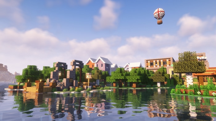 Minecraft village with hot air balloon over water