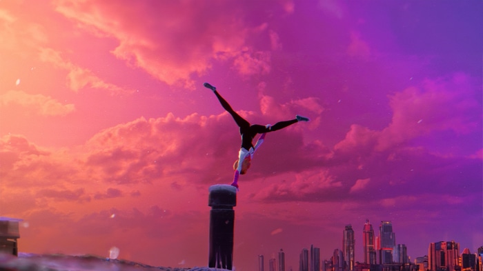 Gwen Stacy performing a handstand at sunset
