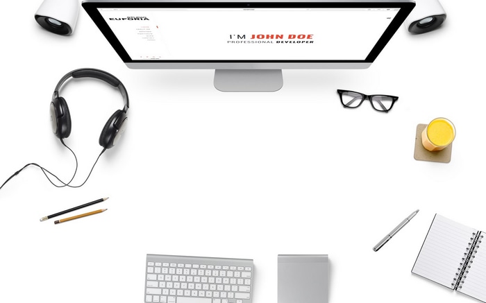 John Doe's professional developer workspace with computer and headphones