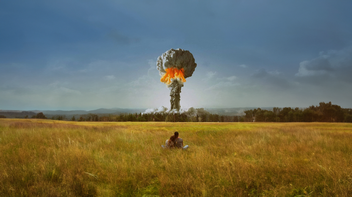 Couple watches nuclear explosion in a field