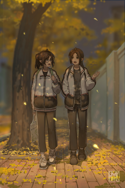 Two girls walking on a path covered in leaves
