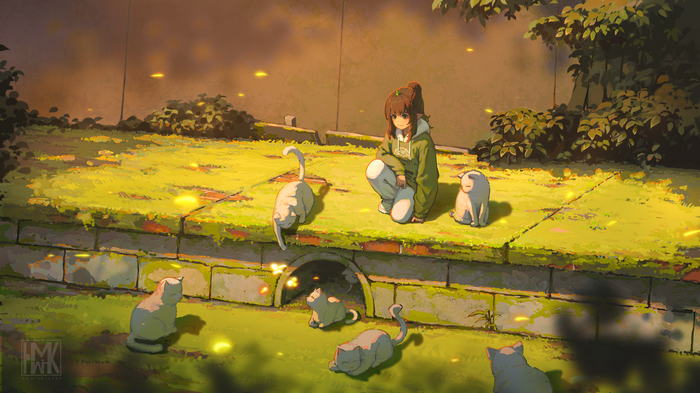 Girl with cats in a sunlit grassy area