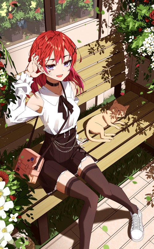Girl with red hair and cat on a bench