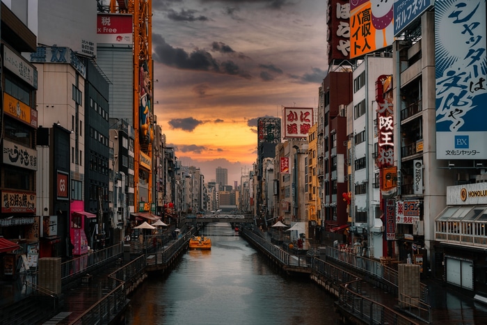 Osaka canal at sunset with neon signs
