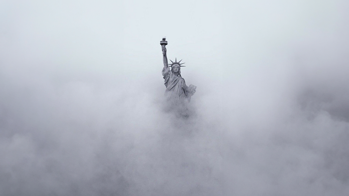 Statue of Liberty emerging from clouds