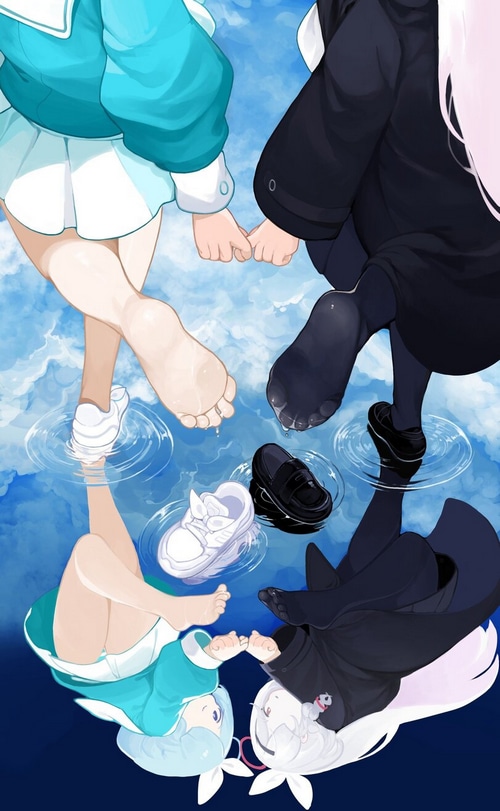 Two girls holding hands with their feet in water