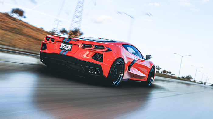 Red Chevrolet Corvette C8 on a blurry road